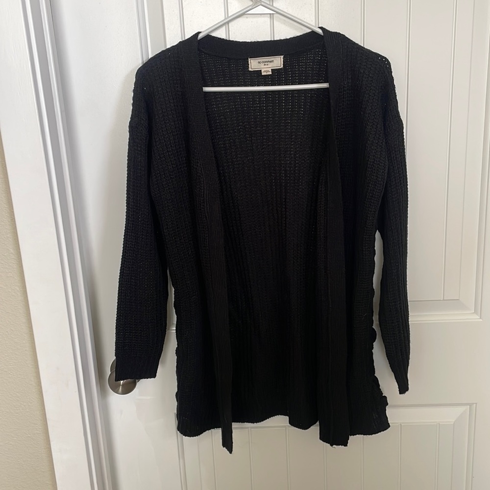 Like new. Small. Black knit cardigan with braided side detail.